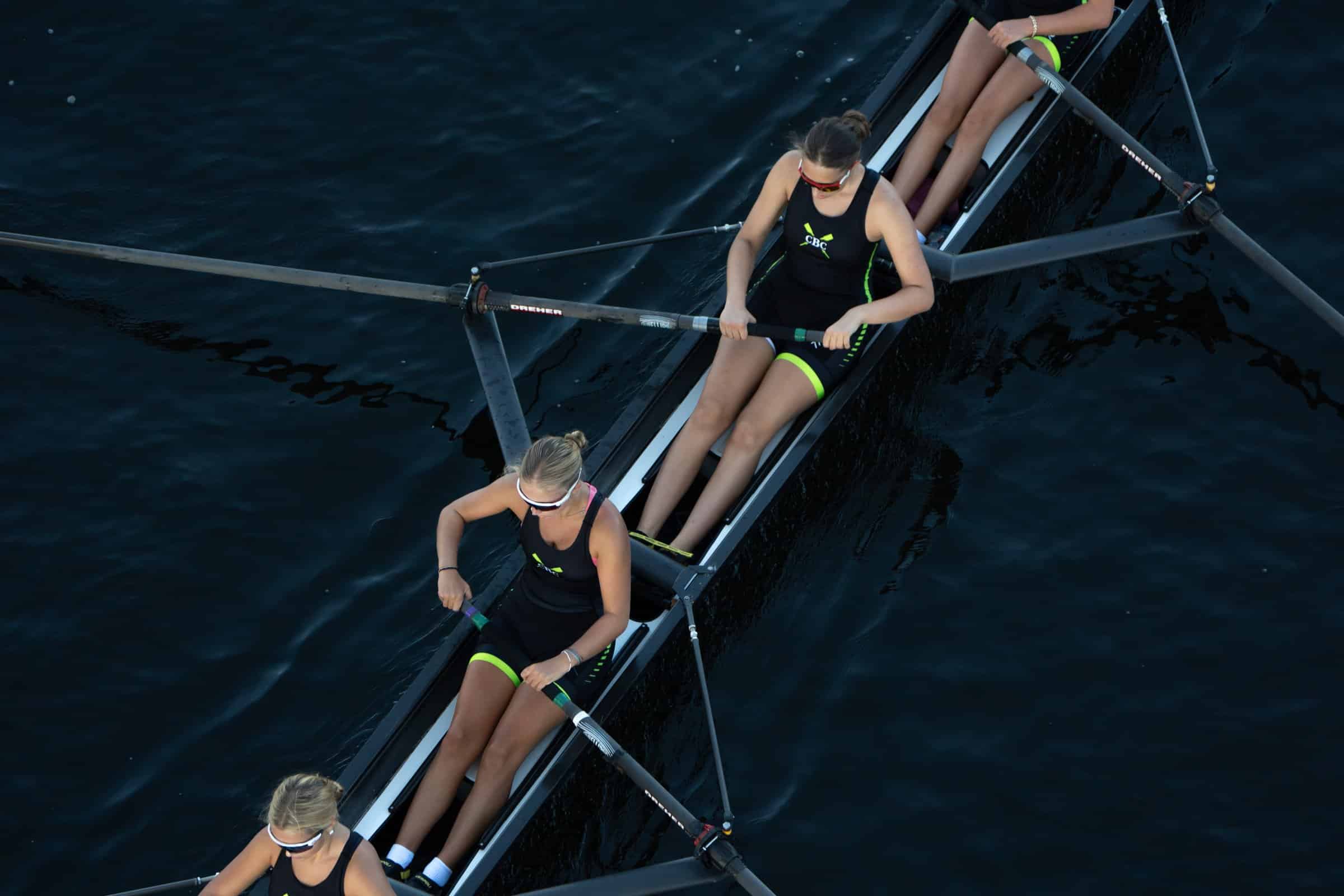 A CBC eight rowing on dark water, seen from above