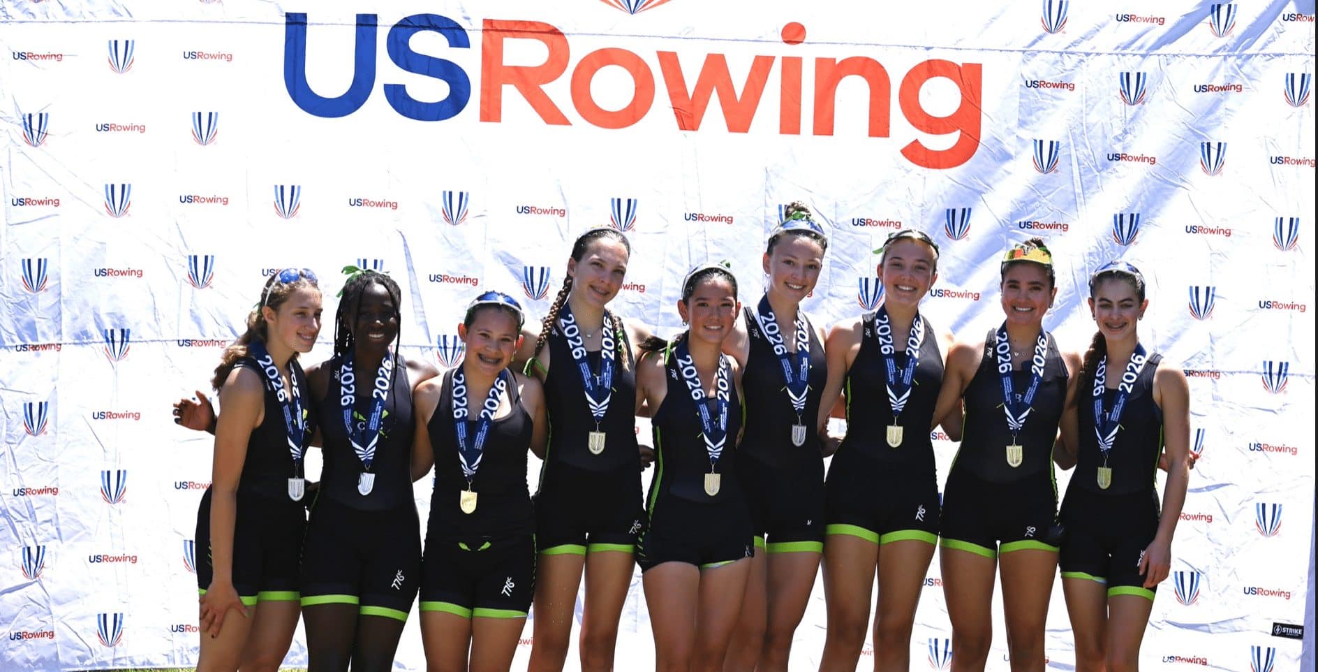 CBC's eight with their medals in front of the USRowing backdrop